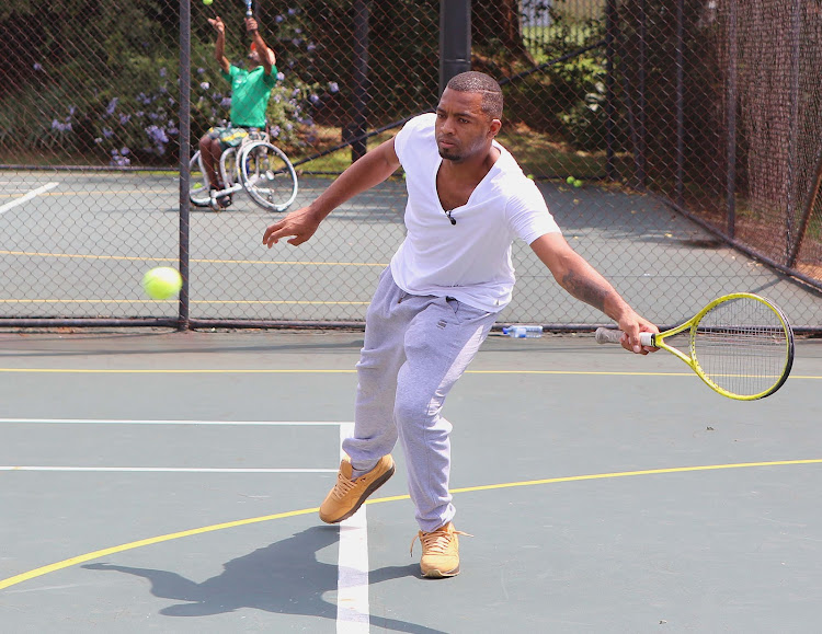 Itumeleng Khune in action during the Itumeleng Khune surprise visit to the practice of Lucas Sithole at University of Johannesburg tennis courts on March 19, 2015 in Johannesburg, South Africa.