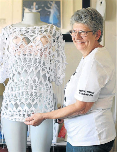 HELPING HANDS: Sonja Schoeman shows off one of her crocheted garments which she sells to fund various outreach projects for the Havencare Centre, as well as for her own weekly feeding scheme Picture: MADELEINE CHAPUT