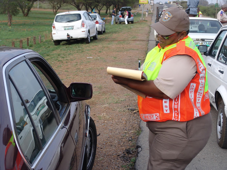 A police officer writing a traffic fine. File photo.