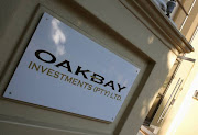 A logo of Oakbay Investments is seen at the entrance of their offices in Sandton, outside Johannesburg, South Africa April 13, 2016.