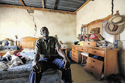 FRACTURED: Frans Nkome poses in his house in Swartdam, in North West. Nkome has been promised R200000 by the Department of Public Works after it agreed to settle his complaint that the construction of a road metres away from his house had damaged it beyond repair.
