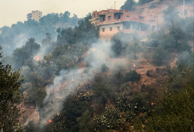 Smoke rises from a forest fire in the mountainous Tizi Ouzou province, east of the Algerian capital, Algiers, August 10, 2021.