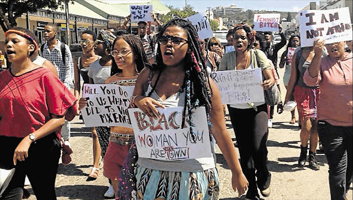 JUSTICE: Angry Rhodes University students march to the Grahamstown Police Station yesterday demanding answers to an alleged attack on a student by two men wearing uniforms Picture: DAVID MACGREGOR