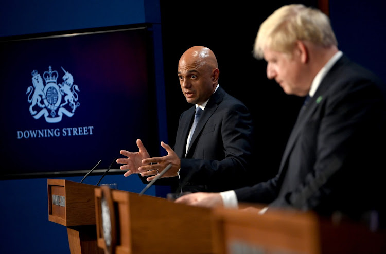 Health minister Sajid Javid, left, and Prime Minister Boris Johnson address the media in London, Britain. Picture: NEIL HALL/EPA/BLOOMBERG