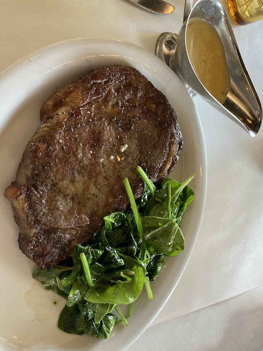 Rib eye steak. Side of sauteed spinach to make it gluten free. Normally comes w fried potato chips and a mushroom Rockefeller