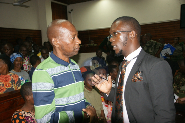 Good News International preacher Paul Mackenzie Paul Mackenzie talking to his lawyer, Lawrence Obonyo at Mombasa Law Court on Thursday, April 25, 2024.