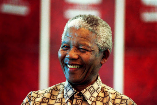 Former President Nelson Mandela of South Africa smiles as he talks to visitors on March 8, 1999 in his residence in Houghton, a suburb of Johannesburg, South Africa.