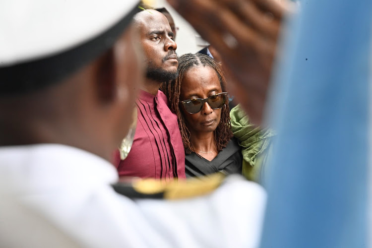 Aileen Ogolola, widow to the late CDF General Francis Ogolla with their son Joel Rabuku during the burial ceremony at his home at Ngiya Village in Siaya County on April 21, 2024.