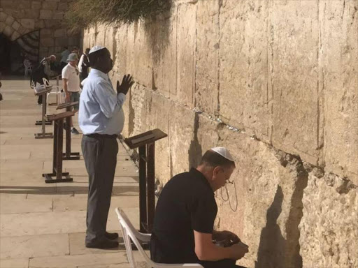 NASA flag bearer Raila Odinga prays at the Wailing Wall in Israel. /COURTESY
