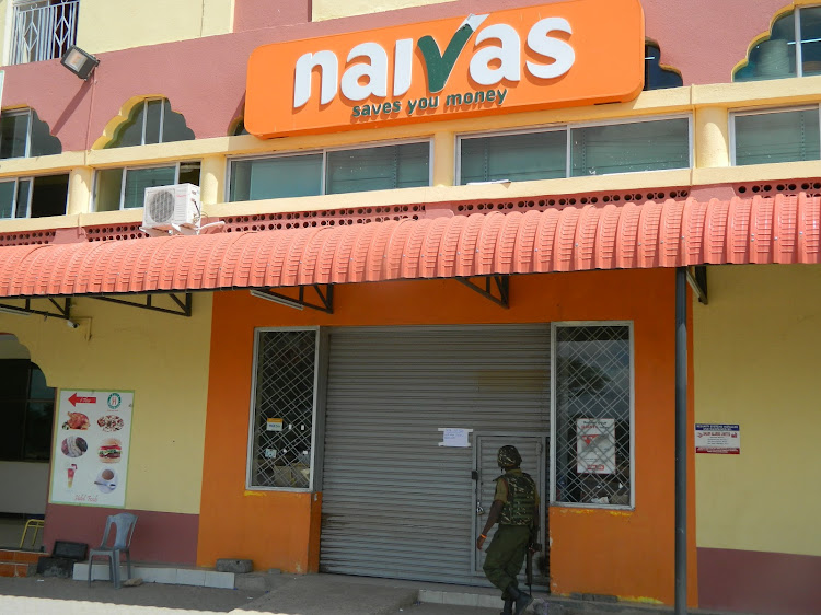 A security officer outside a Naivas Supermarket.