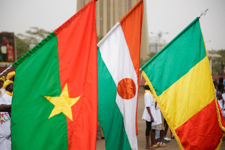 Flags of Burkina Faso, Niger and Mali are seen.