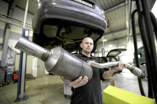 A worker at Twintec, in Königswinter, Germany, with a soot filter catalyst. Catalytic converters for cars use PGM metals platinum, palladium and rhodium.