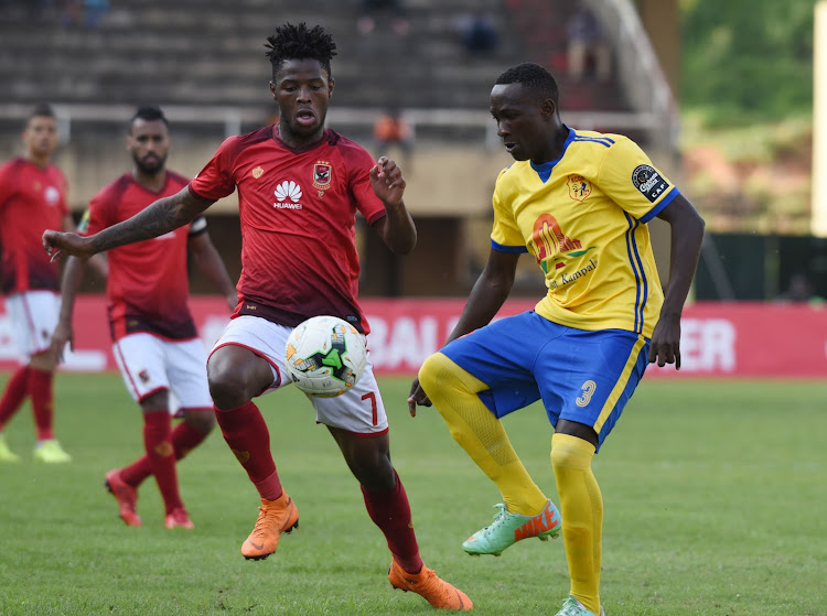 Phakamani Mahlambi of Al Ahly Sporting Club tries to challenge Lawrence Bukenya of Kampala Capital City Authority FC (KCCA) during the 2018 Caf Champions League on 15 May 2018 at Mandela Stadium, Namboole, Kampala.