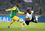 Siphesihle Ndlovu of Orlando Pirates is challenged by Michael Gumede.