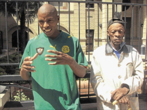 SEEKING JUSTICE: The deceased's brother, Thekiso, and their father Daniel Botsane outside the Bloemfontein High Court yesterday. PHOTO: MICHAEL TLHAKUDI