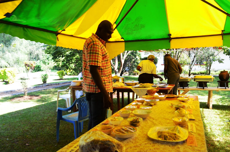 Guests sample foods exhibited at the Eshiembekho shirine in Matungu constituency on Saturday