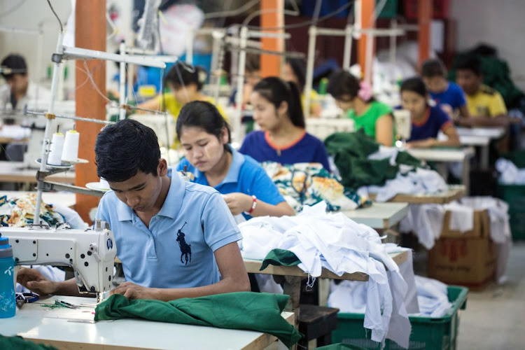 Workers use sewing machines to manufacture shirts at a factory in Yangon, Myanmar. Picture: TAYLOR WEIDMAN
