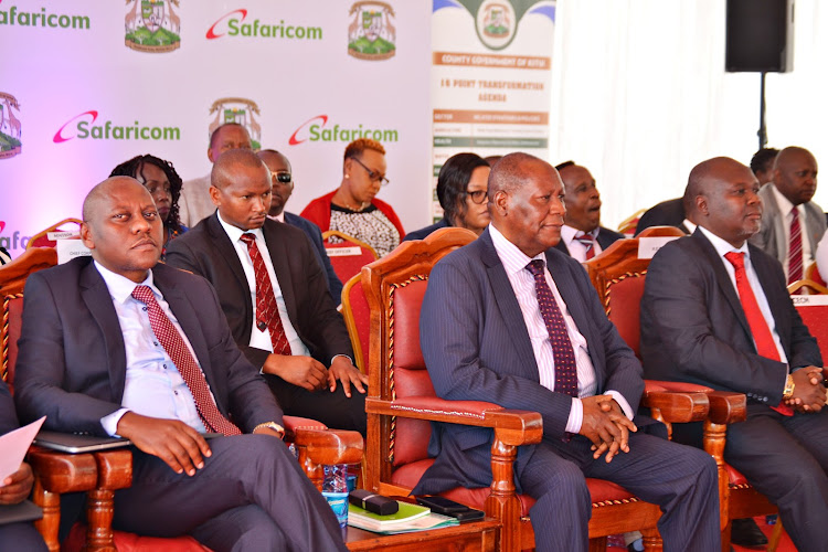 Safaricom Chief Corporate Security Officer, Nicholas Mulila,and the Kitui Governor Julius Malombe and Kitui deputy governor Augustine Kanani during the launch of myCounty App in Kitui on Wednesday.