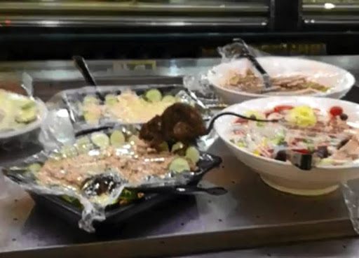 A rat is seen tearing into a salad at Food Lovers Market in Diepkloof.