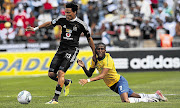 Tlou Segolela of Orlando Pirates slips through an attempted tackle by Elias Pelembe of Mamelodi Sundowns during the MTN8 semi-final first leg played at Orlando Stadium in Soweto yesterday. Pirates won the game 3-2 Picture: SYDNEY SESHIBEDI