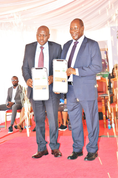 Safaricom Chief Corporate Security Officer, Nicholas Mulila,and the Kitui Governor Julius Malombe as they launched the myCounty App in Kitui on Wednesday.