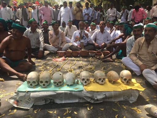 Drought-stricken farmers from India's southern state of Tamil Nadu display the skulls of farmers who have committed suicide due to rising debts at a protest in New Delhi on March 27, 2017. /THOMSON REUTERS FOUNDATION