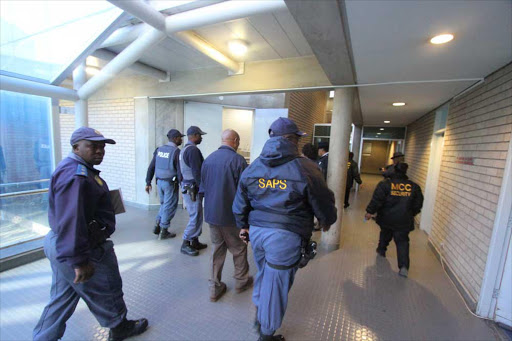 HIGH DRAMA … Police sweep the Mthatha High Court after this morning’s breakout drama. Picture:LULAMILE FENI ​