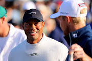 Tiger Woods and Will Zalatoris, both of the US, on the putting green before a practice round for the 2024 Masters at Augusta National Golf Club in Augusta, Georgia.
