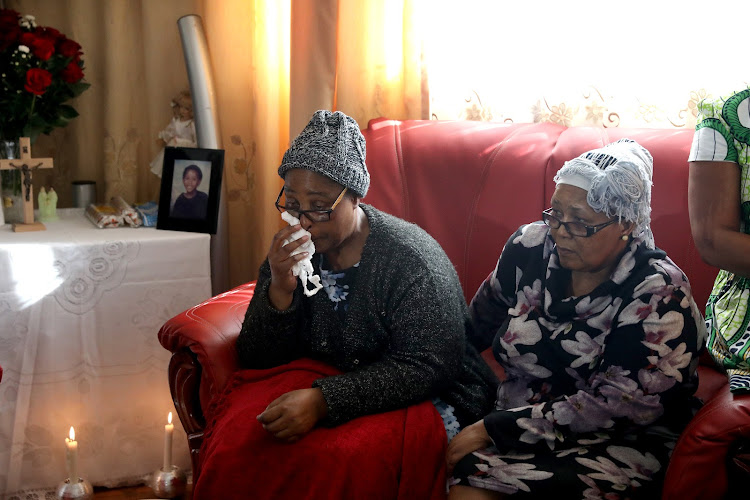 Rosemary Conabeer is comforted by her sister Benedit Goba as she mourns the loss of her daughter Natasha Conabeer, who died on Monday after being missing for three weeks.