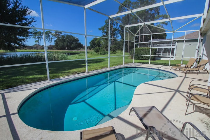 Ridgewood Lakes villa in Davenport with a lake view behind the southwest-facing private pool