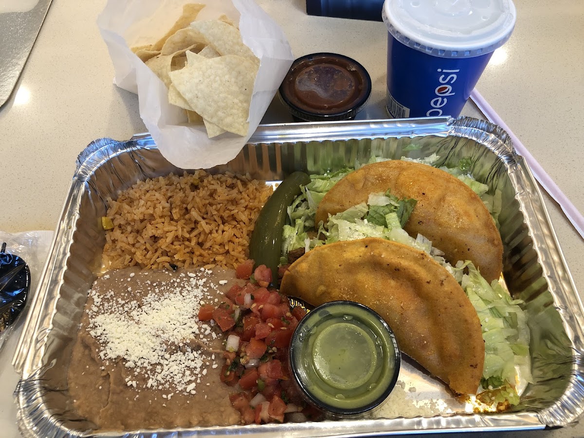 Tacos Don Ramon. Comes with tons of chips, salsa, avocado salsa (nice and refreshing), rice, refried beans with cotija cheese on top, pico, and a pepper.