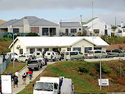 Police and Hawks vehicles at the Department of Agriculture, Forestry and Fisheries building in Gansbaai.