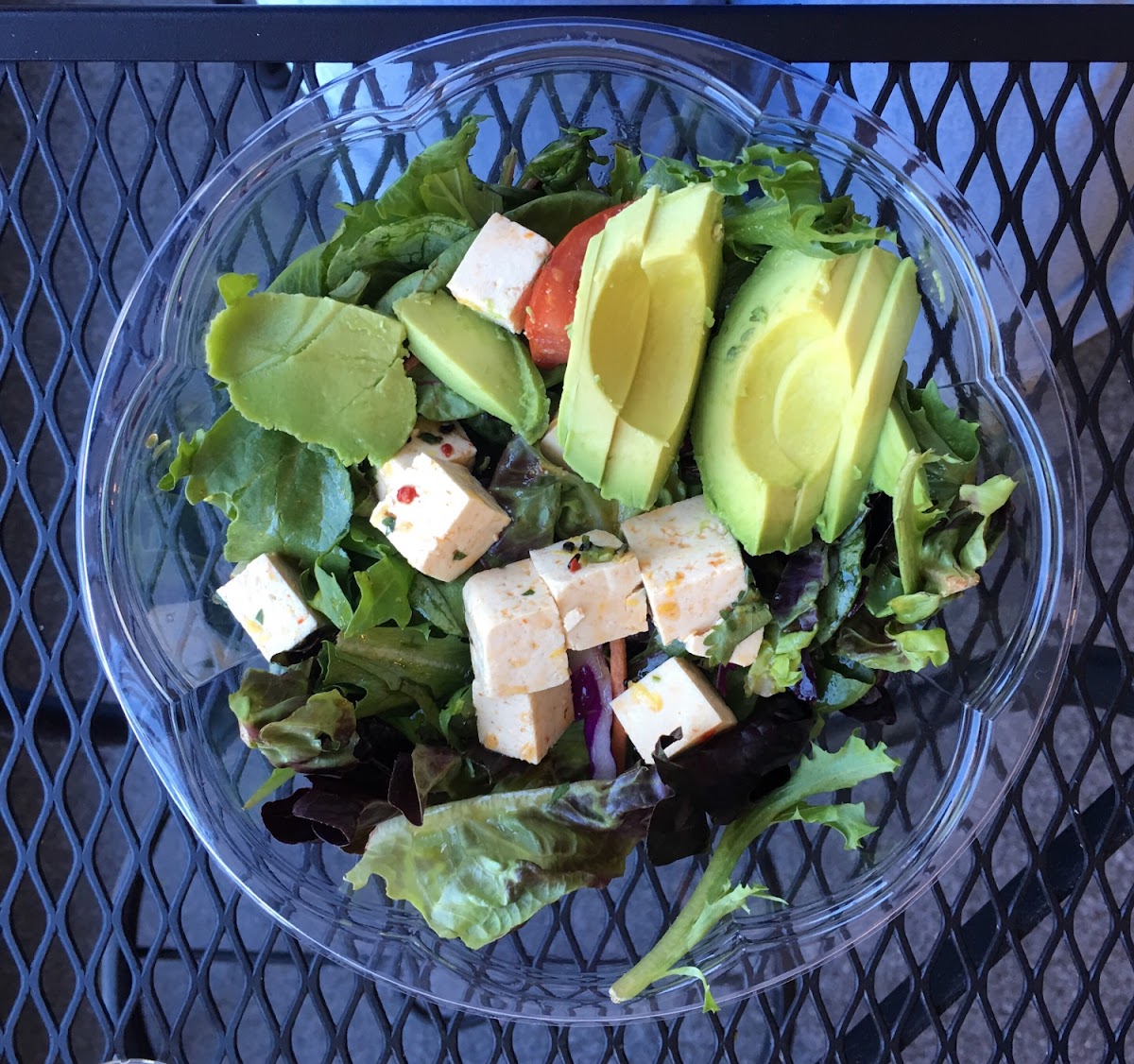 Green salad with marinated tofu and avocado with vinegar and oil dressing.