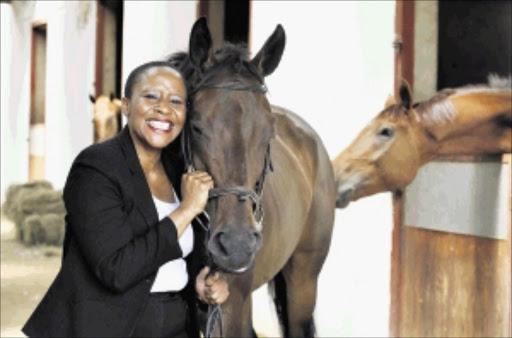 UPBEAT: Phindi Kema, a racehorse breeder from Cape Town, at the stables in Randjesfontein, Johannesburg. PHOTO: Robert Tshabalala. 04/03/2009. © FM. Phindi Kema :Racehorse Breeder from Cape Town at one of the stables in Randjesfontein,JHB 04/03/09 pix Robert Tshabalala