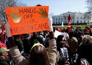 FILE PHOTO: Protesters demonstrate against U.S. President Donald Trump and his plans to end Obamacare outside the White House in Washington. REUTERS/Kevin Lamarque/File Photo