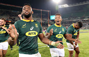 Springbok captain Siya Kolisi (L), Sbusiso Nkosi (C) and Aphiwe Dyantyi (R) celebrate victory over England to seal the three-match Test series 2-0 in a match between South Africa and England at the Free State Stadium, Bloemfontein on June 16 2018.