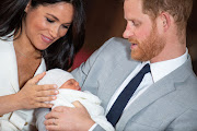 Prince Harry, Duke of Sussex and Meghan, Duchess of Sussex, pose with their newborn son Archie Harrison Mountbatten-Windsor in St George's Hall at Windsor Castle on Wednesday. 