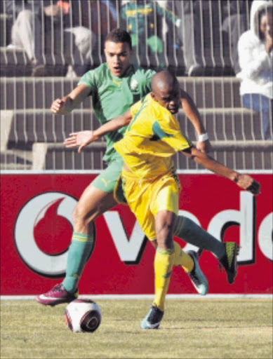 South Africa under-23 player Gladwin Sitholo, right, and Zimbabwe's Mathew Rusike tangle in the All Africa Games qualifier at Sinaba Stadium in Daveyton last week Picture: GALLO IMAGES