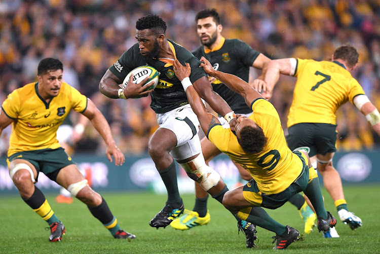 South Africa captain Siya Kolisi pushes away Australia's Will Genia during the Rugby Championship match at the Suncorp Stadium in Brisbane on September 8, 2018.