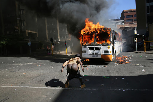 A man is seen pulling his pants down in defiance , after a bus was set alight in the city centre of Braamfontein, Johannesburg. In mid October 2015, a student led protest movement began in response to an increase in fees at South African universities. The Protests started at the University of Witwatersrand (Wits) and spread to various other universities including the University of Cape Town and Rhodes University.