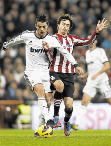 'UNBUYABLE': Real Madrid's Cristiano Ronaldo, left, fights for the ball with Athletic Bilbao's Ander Iturraspe during their La Liga match at Santiago Bernabeu stadium in Madrid on Saturday. Photo: REUTERS
