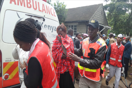 Red cross personnel help family members of the 36 people killed in Mandera after viewing the bodies at the city mortuary. Photo/File