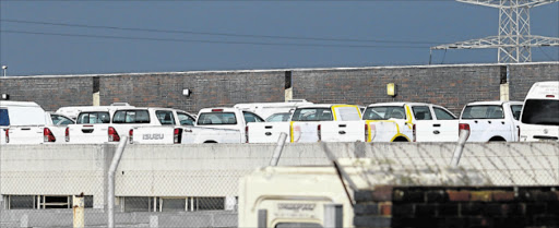 BONE OF CONTENTION: Some of many state vehicles that are at the East London government fleet garage in West Bank, which are fitted with the Afrirent tracking system Picture: MICHAEL PINYANA