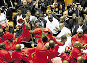 Security officers and EFF MPs scuffle during the State of the Nation address.