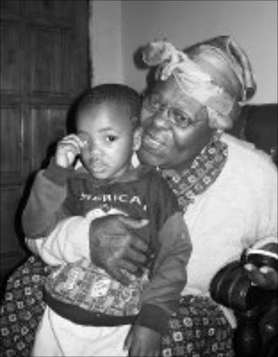 FAMILY COMFORT: Agatha Mthethwa, with her grandson Ayanda, is relieved to be home in Soweto after she and a group of pensioners were stranded at Cape Town station. Pic. Munyadziwa Nemutudi. 28/10/07. © Sowetan.