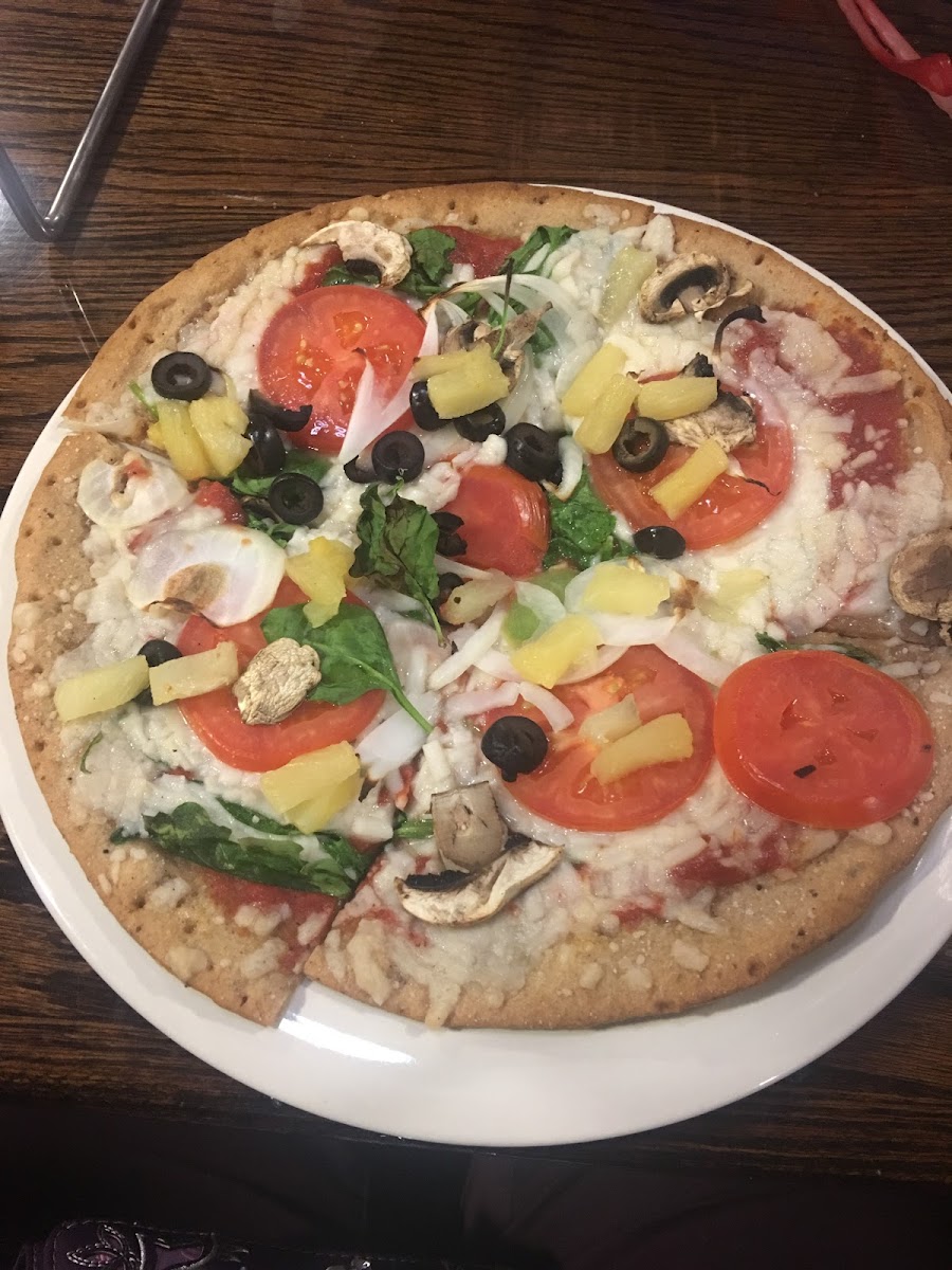 Gluten free veggie pizza with pineapple added.