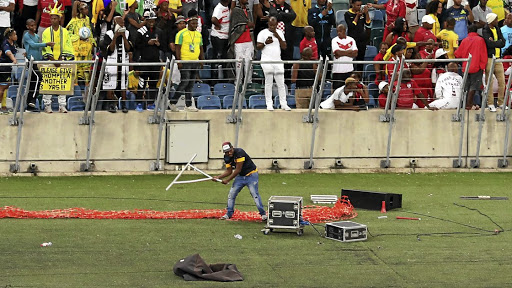 A fan vandalises broadcasters' equipment during a match between Kaizer Chiefs and Free State Stars at Moses Mabhida Stadium in Durban in April.