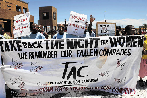 Activists demonstrate outside the Khayelitsha Regional Court in Cape Town during the appearance of four men convicted of having killed Zoliswa Nkonyana, a 19-year-old lesbian