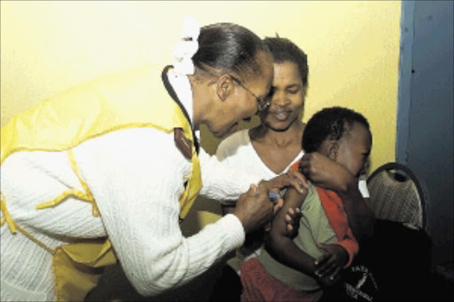 Julia Mokale had a busy day at the Olivenhoutbosch Community Hall near Centurion during the launch of a mass immunisation campaign for polio and measles yesterday, an addition to the routine immunisation programme that is carried out by clinics throughout Gauteng. PIC: PETER MOGAKI. 26/07/2004. © Sowetan.