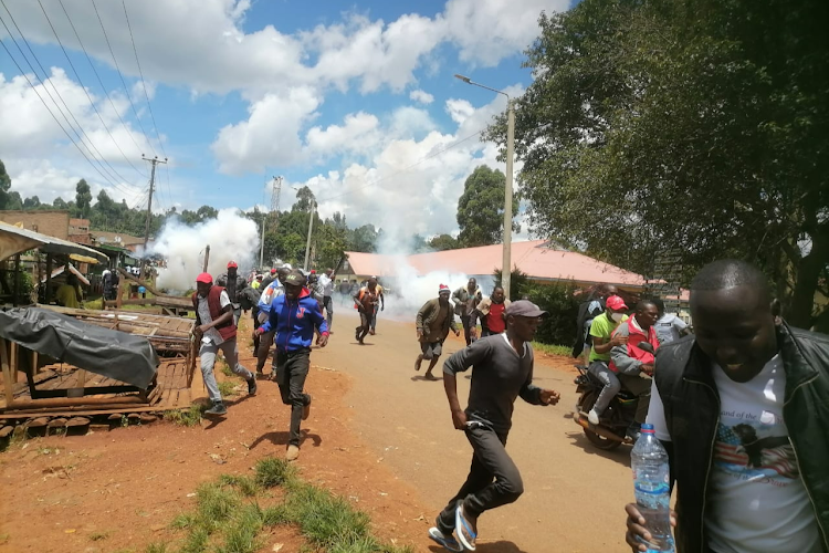 Police disperse residents of who were protesting delayed repairs to a dilapidated briedge in the area.